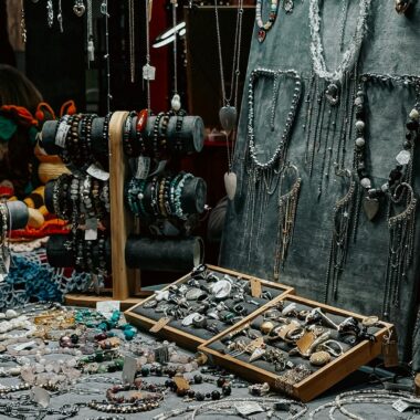 Artistic display of handmade jewelry in a vibrant market setting.