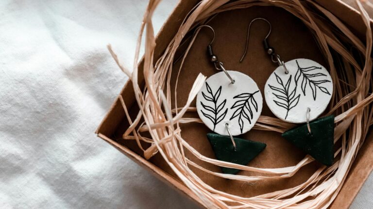 Close-up of handcrafted leaf-design earrings in a rustic gift box, perfect for nature lovers.