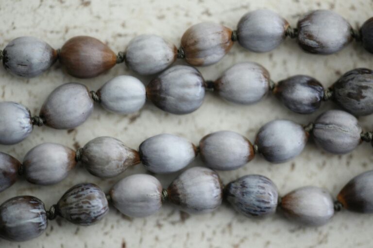 Close-up of natural seed necklaces showcasing organic texture and earthy tones.