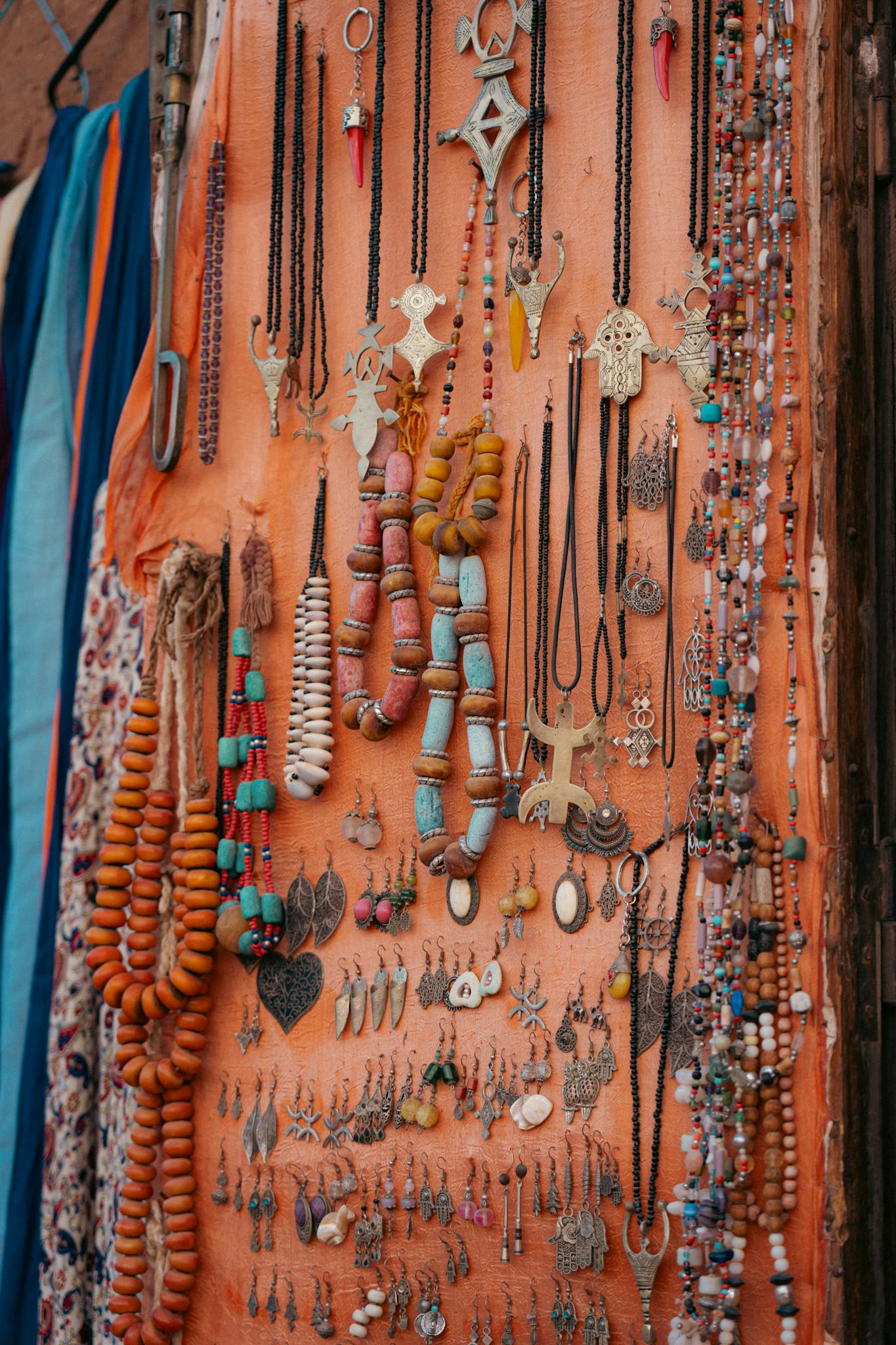 Vibrant collection of handmade necklaces and bracelets displayed on draped fabric, showcasing traditional craftsmanship.